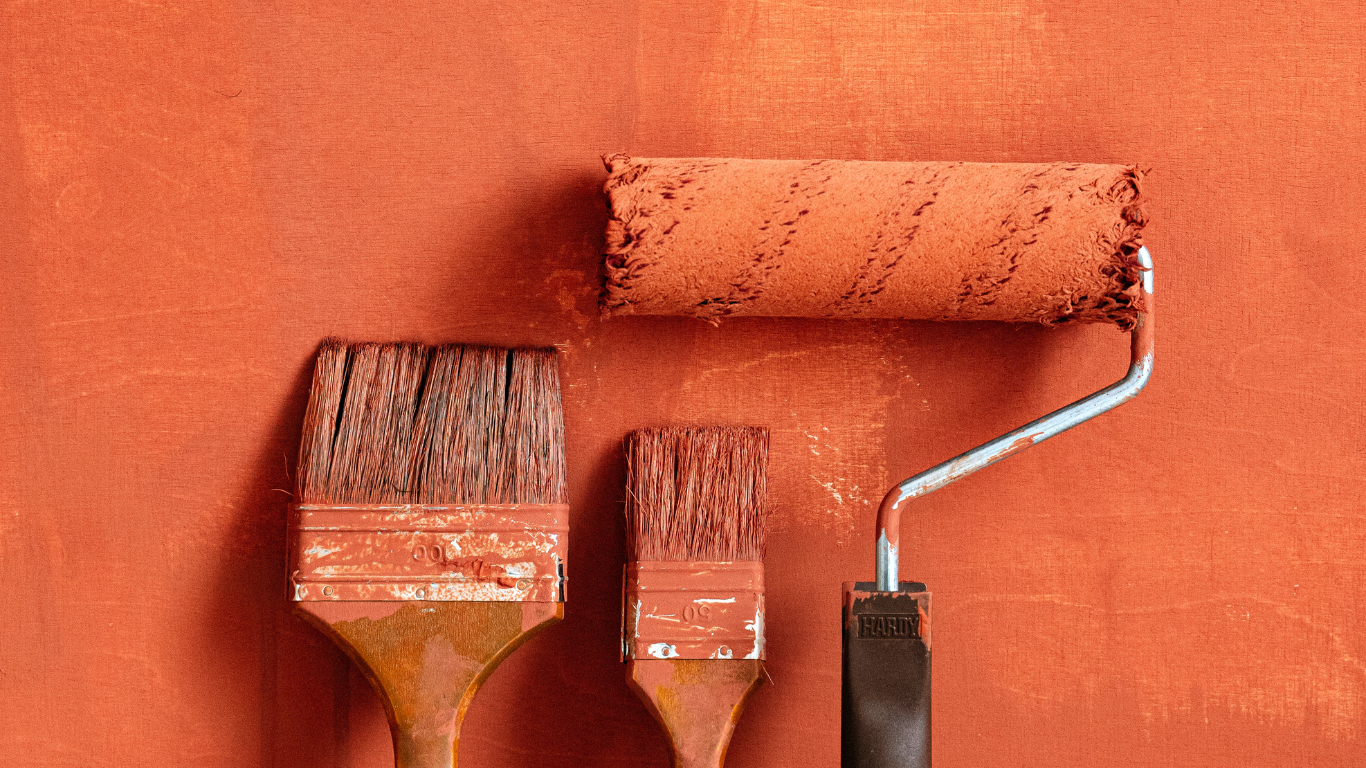 Three painting tools covered in orange paint after completing a professional painting job by Elite Painting & Drywall