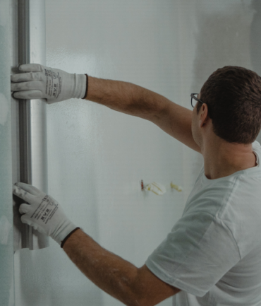 Expert team member applying drywall plaster to wall during painting and drywall services for residential and commercial property renovation